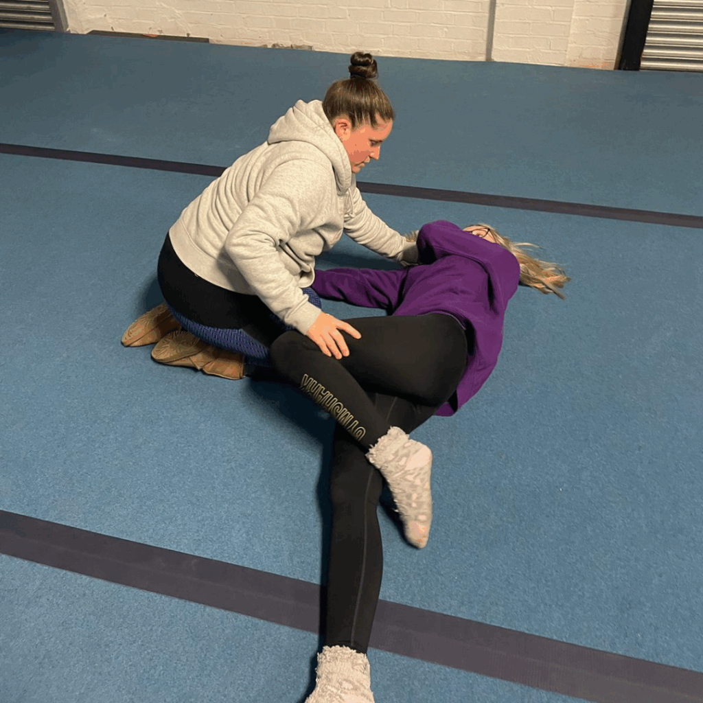 Bellstone Training participant practicing the recovery position during a first aid training session.